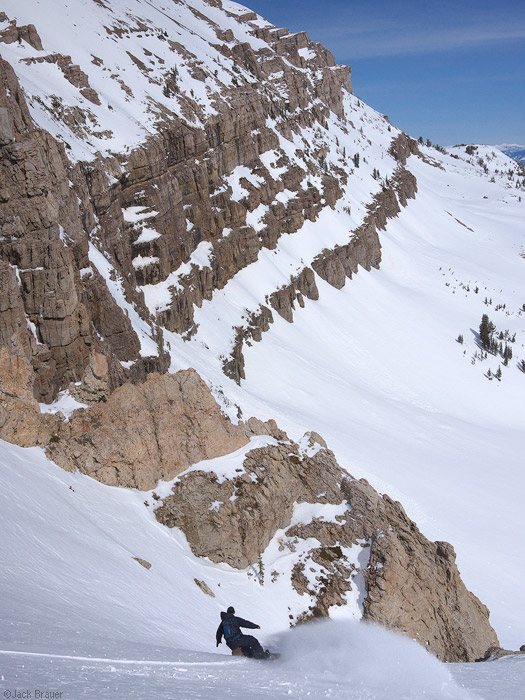 Snowboarding into a steep couloir